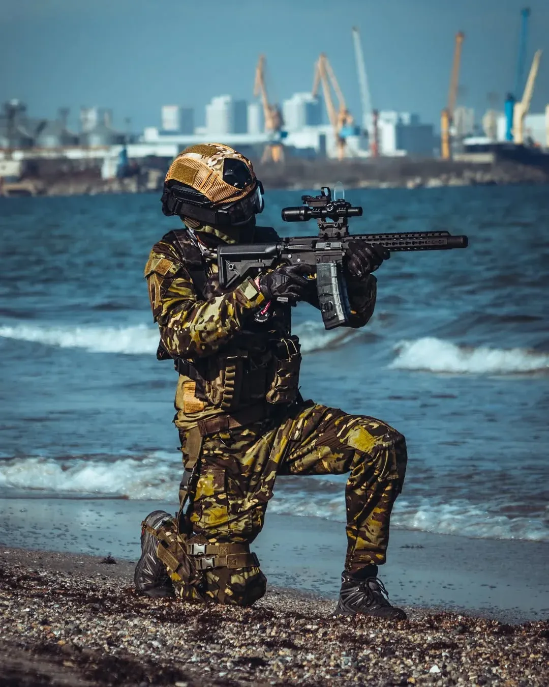 Niko wearing his airsoft loadout by the sea